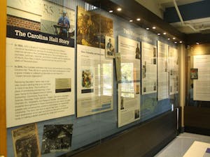 A permanent exhibit in the entrance of Carolina Hall detailing the building's history. The hall was originally named for William Saunders, former leader of the N.C. Klan and UNC Trustee.