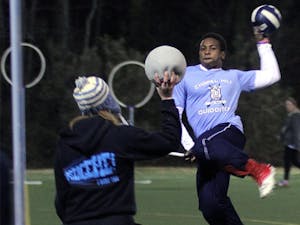 Lee Hodge jumps before attempting to score while Jessica McAfee defends during a Wednesday night quidditch practice.