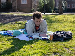 Ben Boatwright, second year at the UNC School of Law, reads a book at McCorkle Place in Chapel Hill on March 7, 2021.