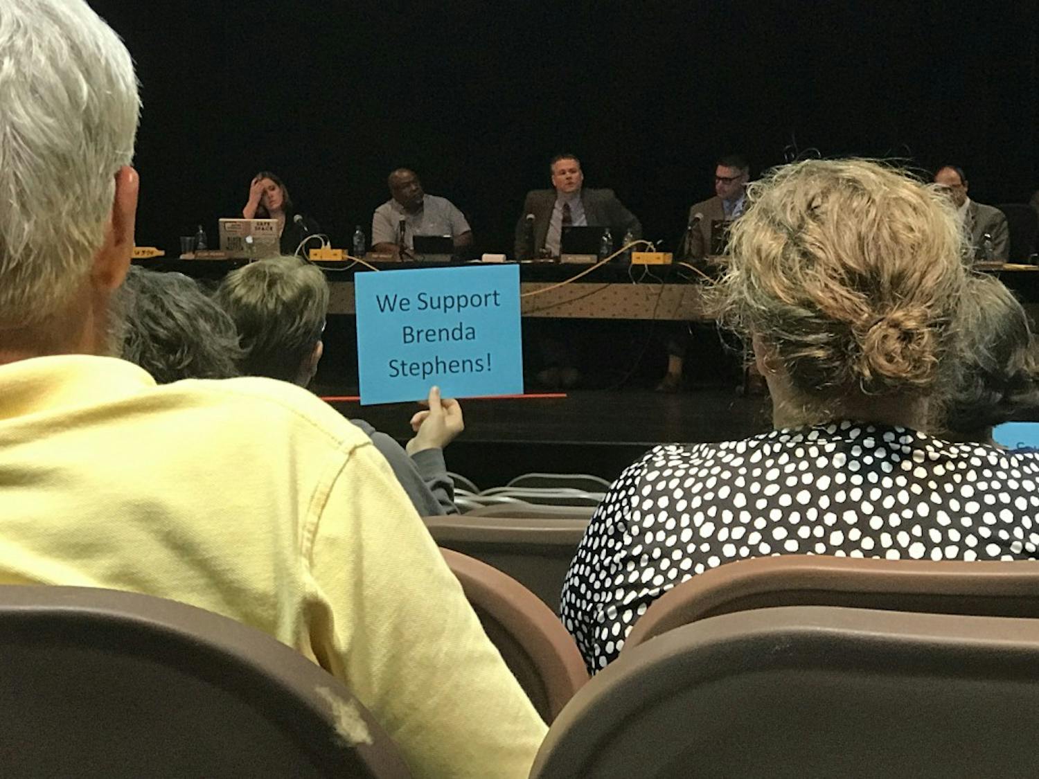 Community members holding signs at the Monday, May 20 Board of Education meeting for Orange County.&nbsp;