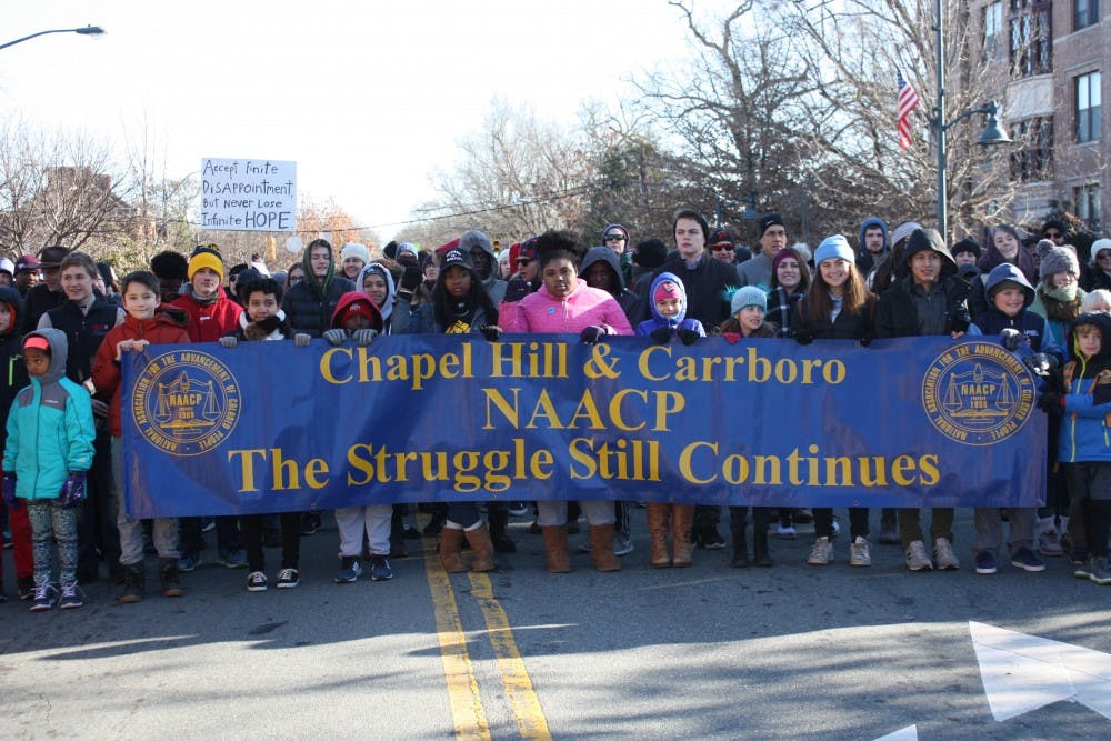 Attendees of the Chapel Hill-Carrboro NAACP MLK Day Rally and March walk down Franklin St. in 2018.