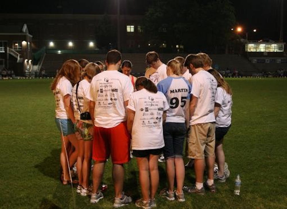 Students gather and reflect after the luminaries are lit Friday night. DTH/BJ Dworak