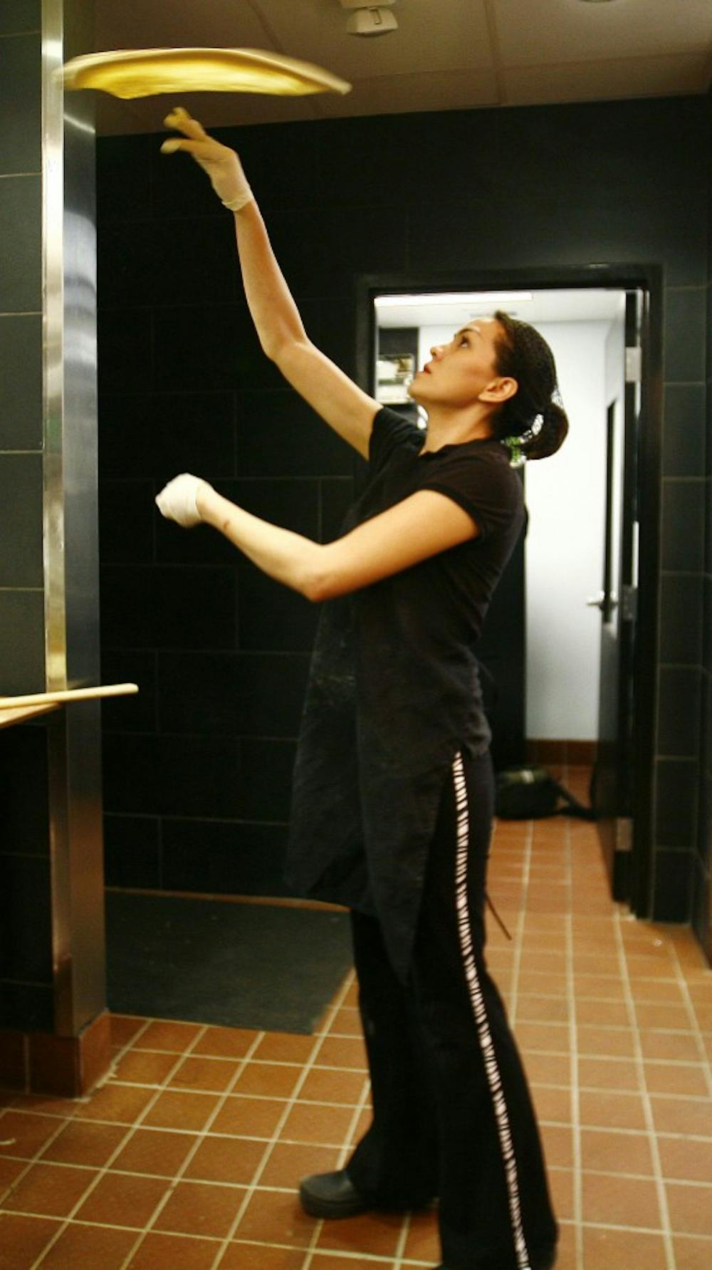 Yalu Rivas tosses pizza dough at Friday's training night. "I think it's one of the best pizzas," she said. 