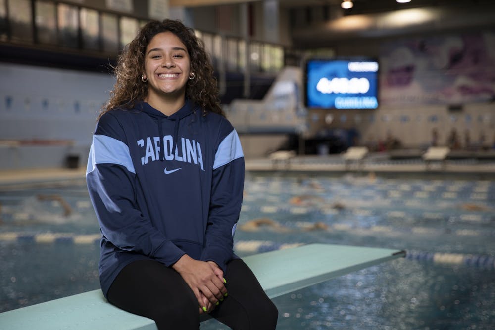 Aranza Vazquez sits on a diving board in Koury Natatorium on Monday, March 27, 2023. Vazquez is the first UNC diver to hold an NCAA title. Photo courtesy of Ira Wilder. 