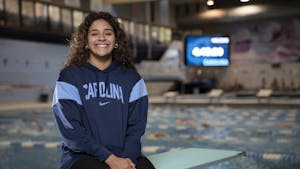 Aranza Vazquez sits on a diving board in Koury Natatorium on Monday, March 27, 2023. Vazquez is the first UNC diver to hold an NCAA title. Photo courtesy of Ira Wilder. 