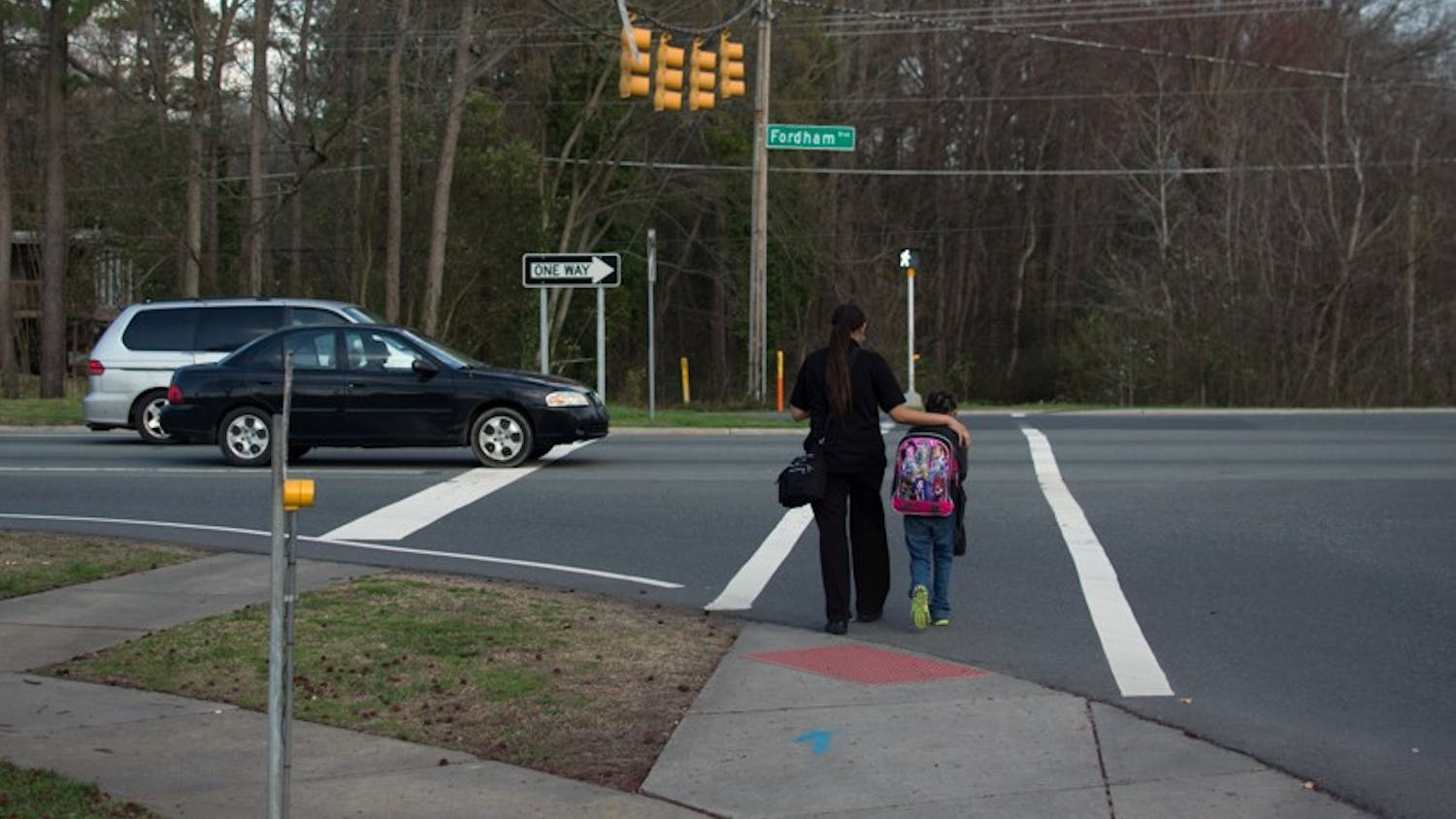 Pedestrians use the crosswalk on Fordham Boulevard. The Town Council is working on finding new locations for crosswalks.