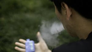 A UNC student vapes at Polk Place on Wednesday, April 5, 2023.