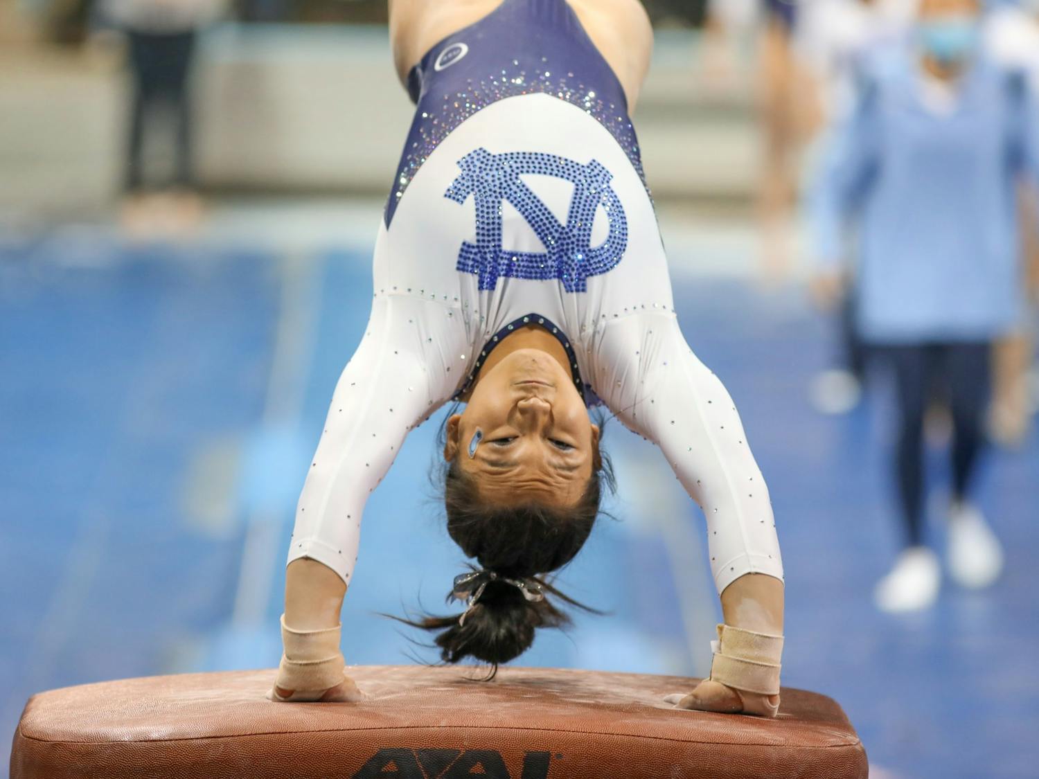 Sophomore Cory Shinohara pushes off the vault during UNC gymnastics' home meet in Carmichael Arena on Friday, Jan. 7, 2022.