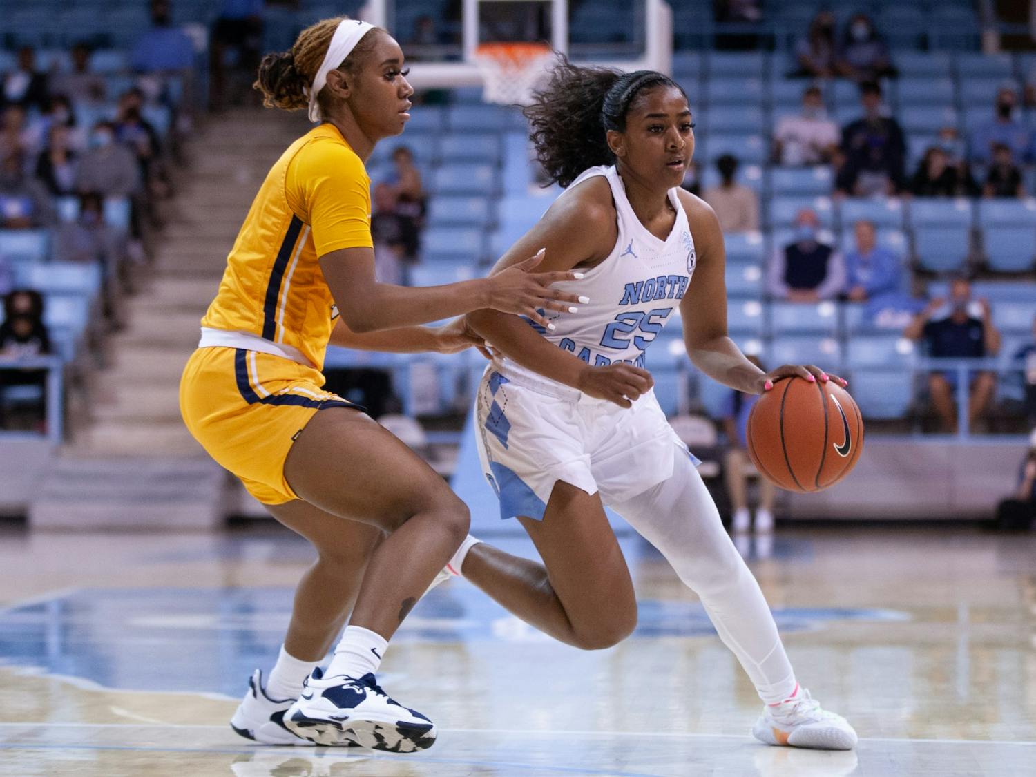 Sophomore guard Deja Kelly (25) runs with the ball at the game against NC A&T on Nov. 9 2021 at Carmichael Arena. UNC won 92-47.