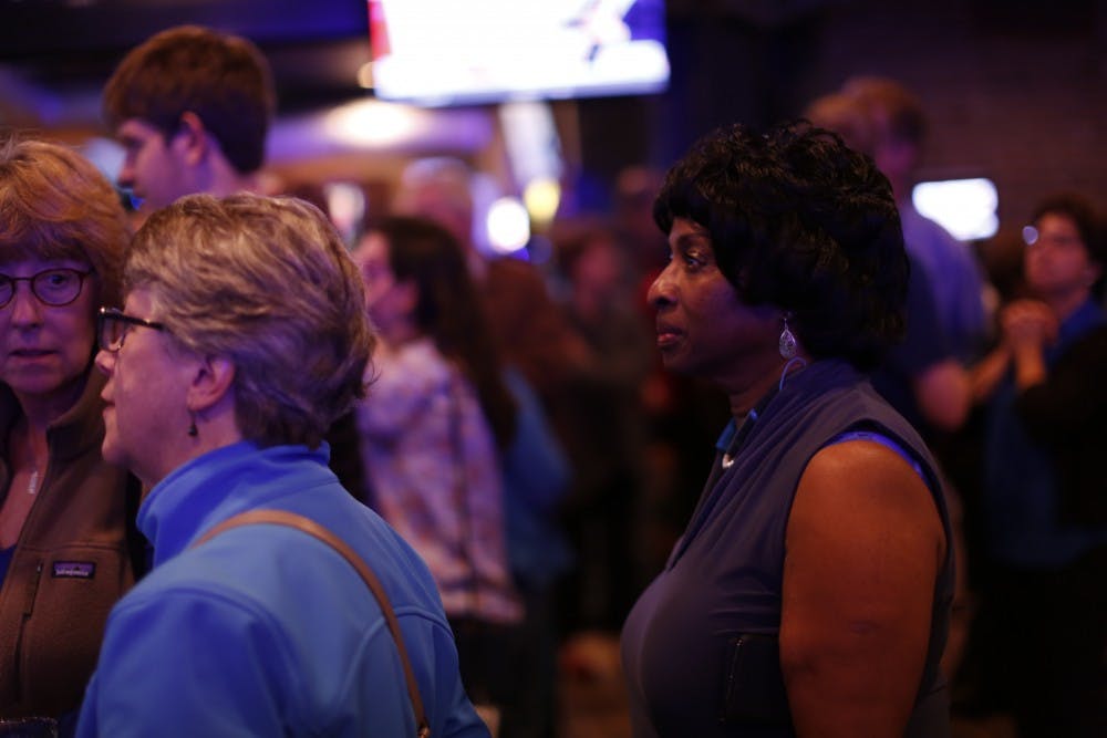 <p>Valerie Foushee looks at voting updates during the Orange County Democratic Party's election party at Might as Well in Chapel Hill.</p>