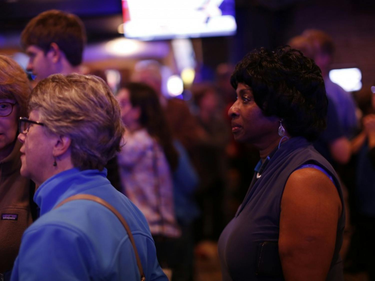 Valerie Foushee looks at voting updates during the Orange County Democratic Party's election party at Might as Well in Chapel Hill.