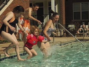 Special Olympics athlete Steffie Madden, Orange County program coordinator Colleen Lanigan and her daughter Ila, and athlete Steve Fromberg make the jump into cold water during Saturday's Polar Plunge fundraiser.