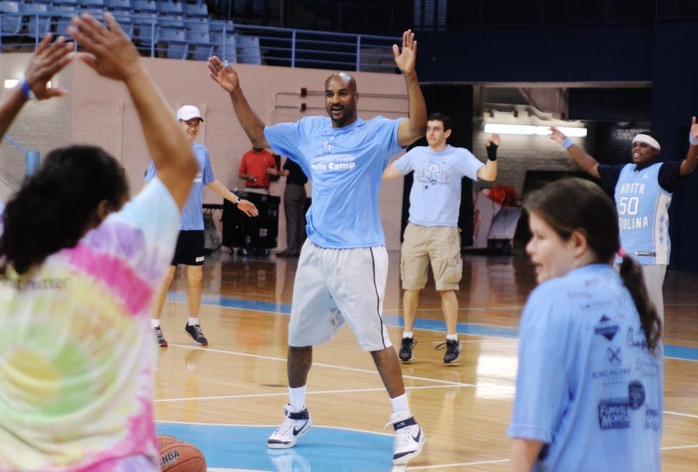 Basketball game for autistic kids at Carmichael Arena

In the center, Roger Hudson, a Tar Heel volunteer who studied Political Policy and graduated in 1996, is leading the kids for some warm-up exercises.
