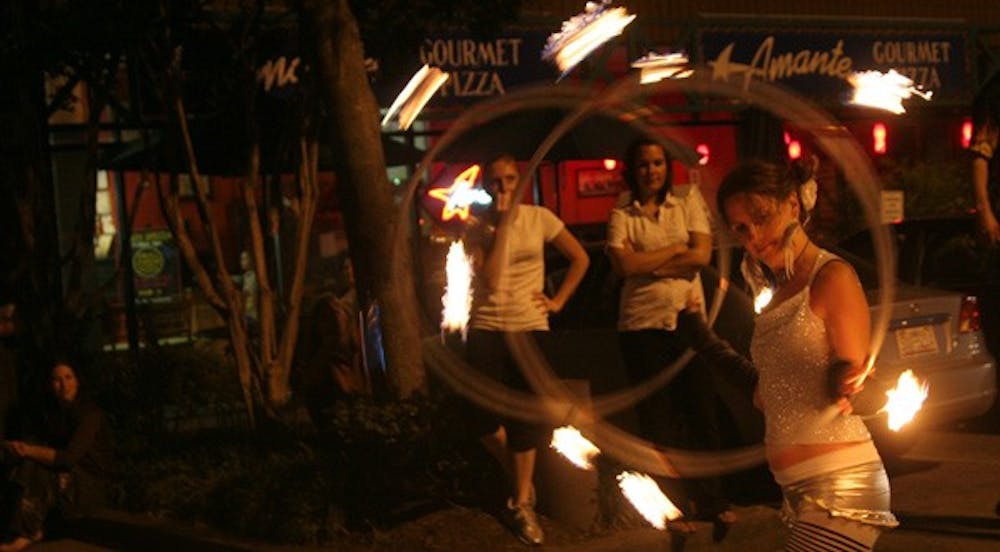 Professional hoop dancer Julia Hartsell spins two flaming hoops outside The ArtsCenter. DTH/Becca Brenner