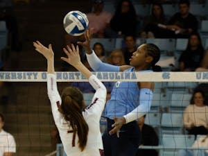 UNC senior middle hitter Skyy Howard (8) tips the ball over the net during the game against Florida State on Oct. 2, 2022. UNC lost to Florida State 2-3.
