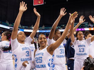 The UNC women's basketball team waves to the crowd in celebration after the game against Clemson University in the second round of ACC Tournament in Greensboro, NC. UNC won 68-58.