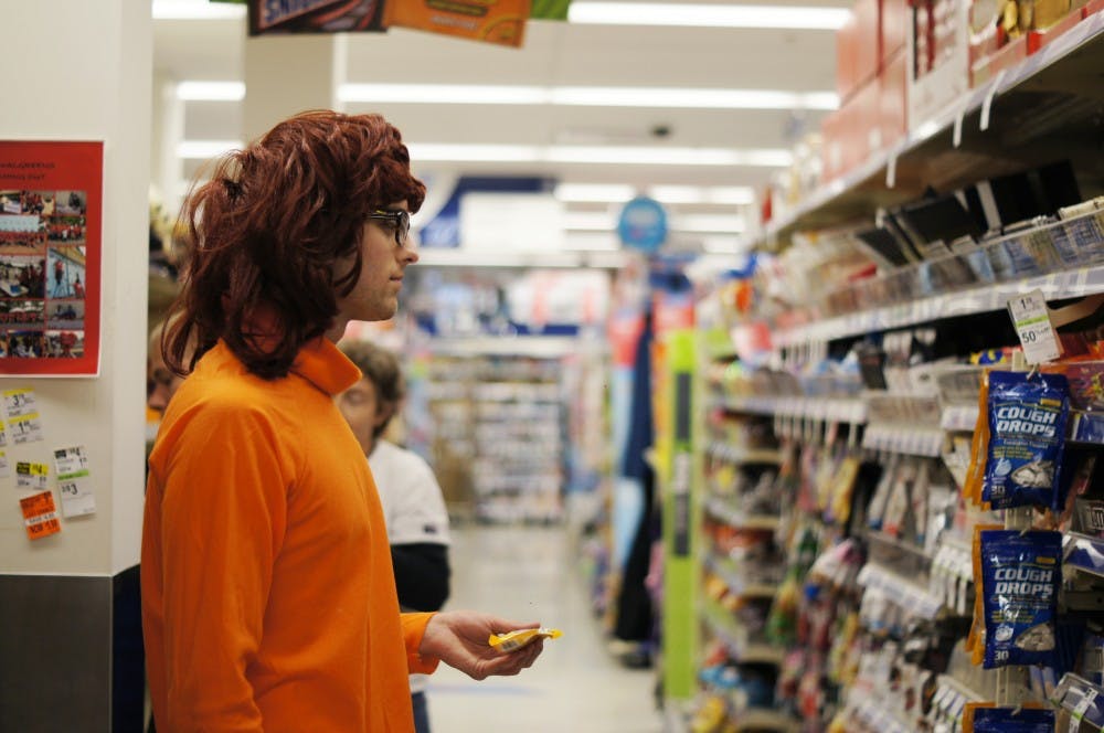 First-year UNC student Adam Oppenheimer dressed up as Velma from Scooby Doo debates what kind of candy he should buy.