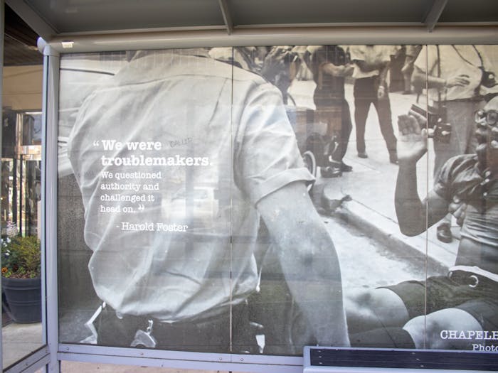 A bus stop in Chapel Hill displays a photo of civil rights activist Harold Foster on Tuesday, Feb. 21, 2023. On the display is a quote from Foster, reading, "We were troublemakers. We questioned authority and challenged it head on."