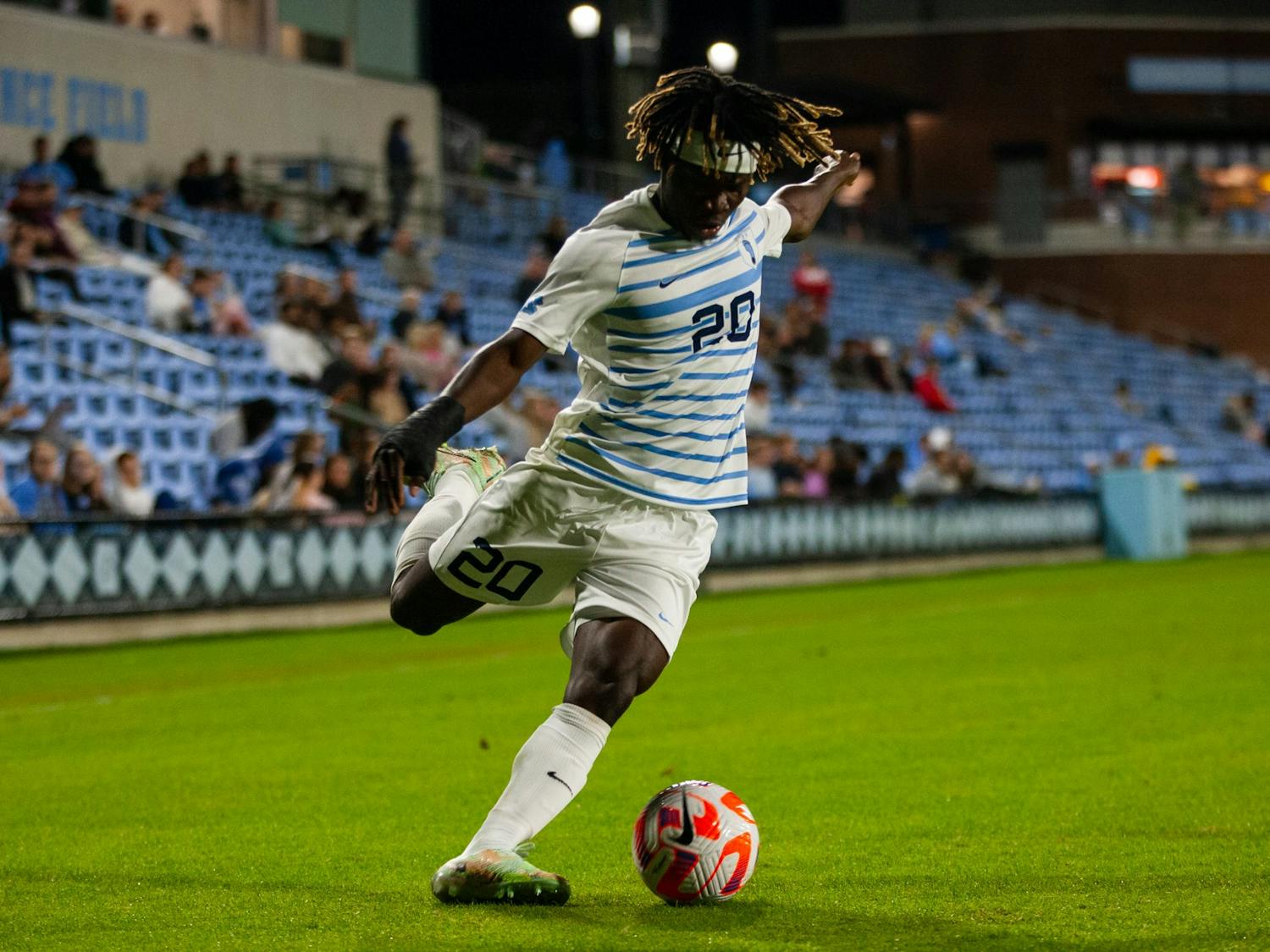 UNC junior forward Ernest Bawa (20) passes the ball during UNC's 1-0 victory against VCU on Tuesday, Oct. 11, 2022, at Dorrance Field.