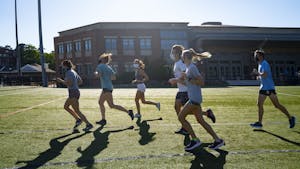 Members of UNC Running club run together in masks across Hooker Fields to warm up on Friday, Sept. 4, 2020. They are happy to be able to continue practicing together with new precautions in place amid the COVID-19 pandemic.