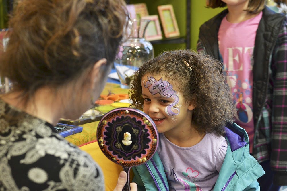 Olivia, 6, got her face painted at the 300 East Main development open house Saturday. “My favorite thing about Frozen is Olaf because he’s funny,” Olivia said. 