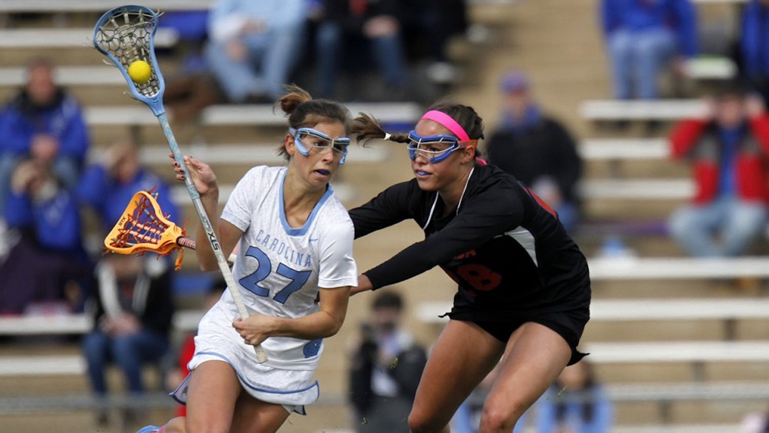 Aly Messinger (27) muscles her way past a Florida defender on Saturday at Fetzer Field. The Tar Heels won 20-8.