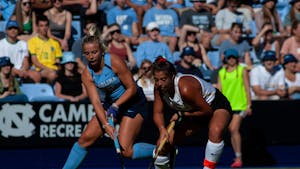 UNC first-year midfielder Ryleigh Heck (12) reaches for the ball during the Tar Heels' 1-0 victory against Wake Forest on Friday, Sept. 23, 2022, at Karen Shelton Stadium.