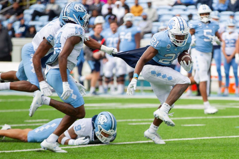 Elijah Green (21), sophomore running back, works to make a play during UNC football's spring scrimmage on April 9, 2022, in Chapel Hill, NC.