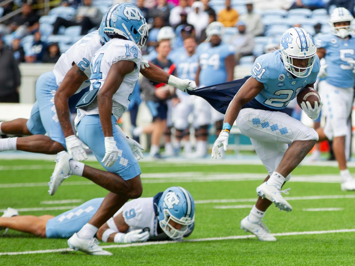 Elijah Green (21), sophomore running back, works to make a play during UNC football's spring scrimmage on April 9, 2022, in Chapel Hill, NC.