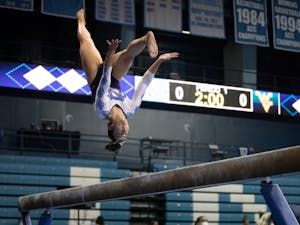 UNC senior Julianna Love performs on the beam during a gymnastics meet against West Virginia on Thursday, Feb. 24, 2022, at Carmichael Arena. UNC lost 195.225 - 196.250.