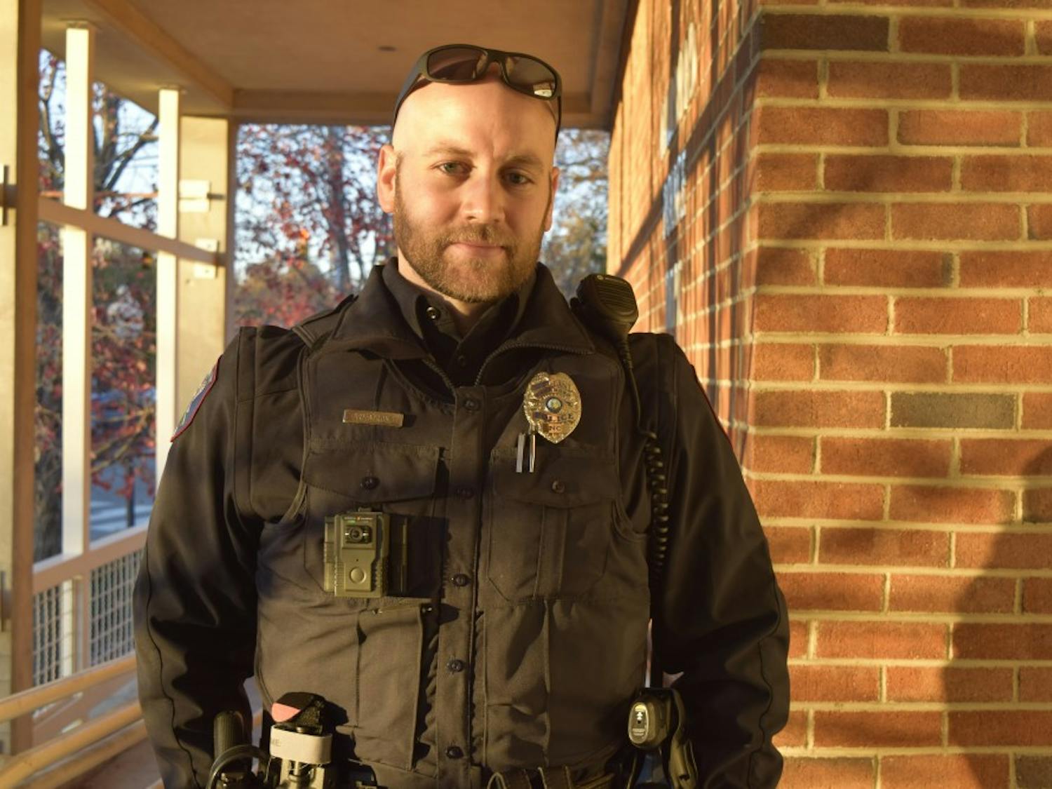 Sgt. Armstrong, a police officer in Carrboro, displays his WatchGuard body cam outside the Carrboro Police Station Wednesday, Nov. 28. The Carrboro Police Department recently received body cams for their officers to use while in the field. 