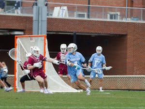 Graduate attackman Chris Grey (4) attacks the goal at the lacrosse game against Colgate at Dorrance Field on Feb. 13, 2022. UNC won the game 15-9.