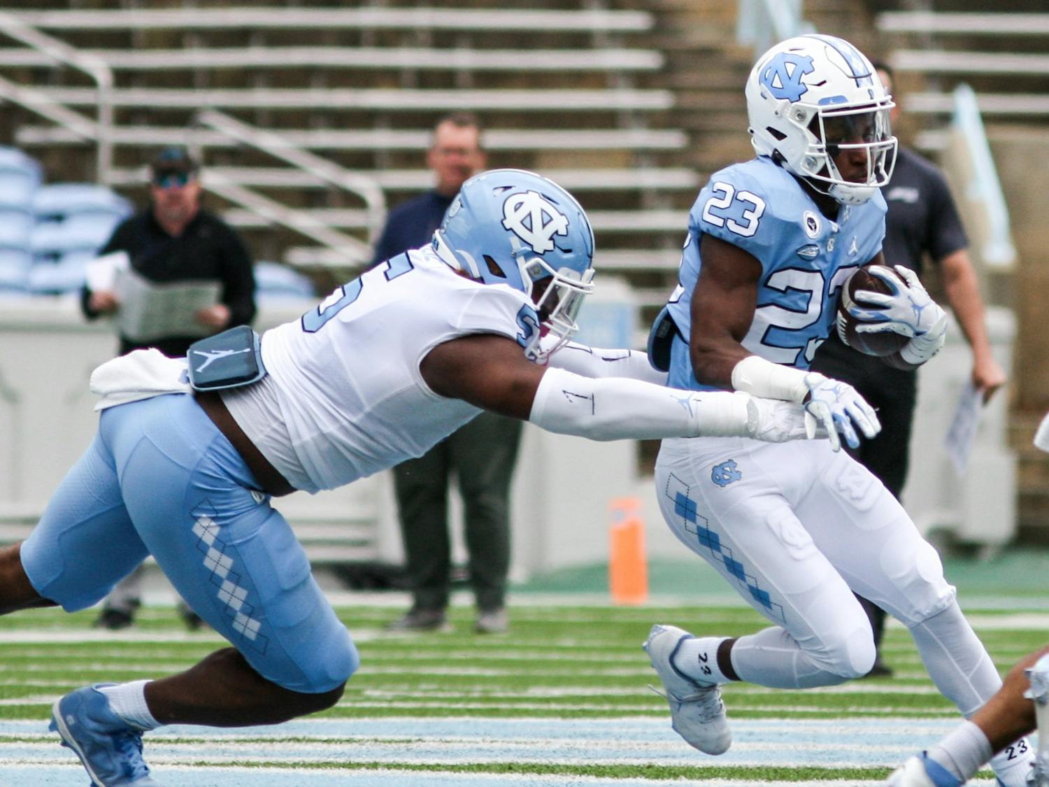 Freshman running back George Pettaway (23) breaks through the defensive line in the Spring Game on Saturday, April 9, 2022. The Tar Heels and Carolina tied, 14-14.