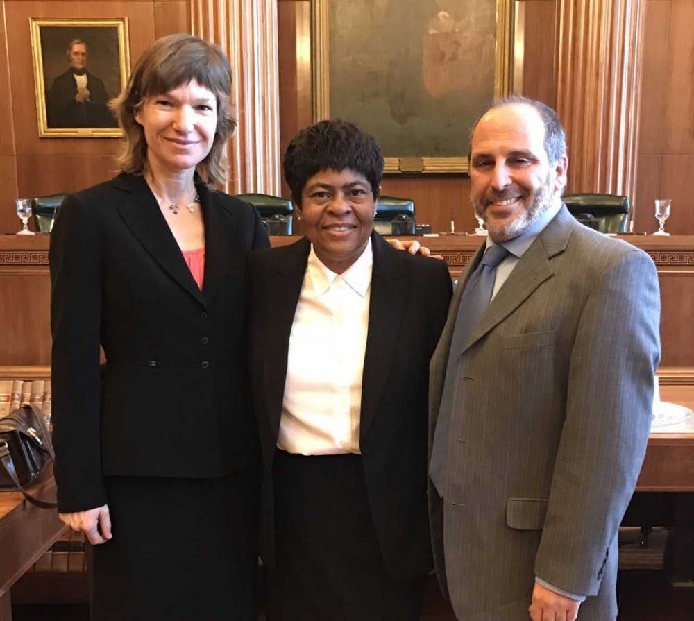 <p>UNC law professor Elizabeth Haddix, left, and the center's managing attorney and UNC law professor Mark Dorosin, right, with Virginia Ingram. Photo courtesy of Haddix.</p>