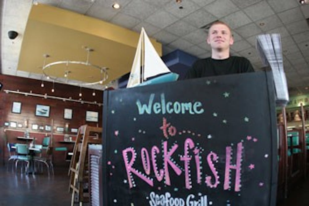 John Knechtel, a May graduate, works as a host Tuesday afternoon at Rockfish Seafood Grill at Southpoint Mall in Durham. 