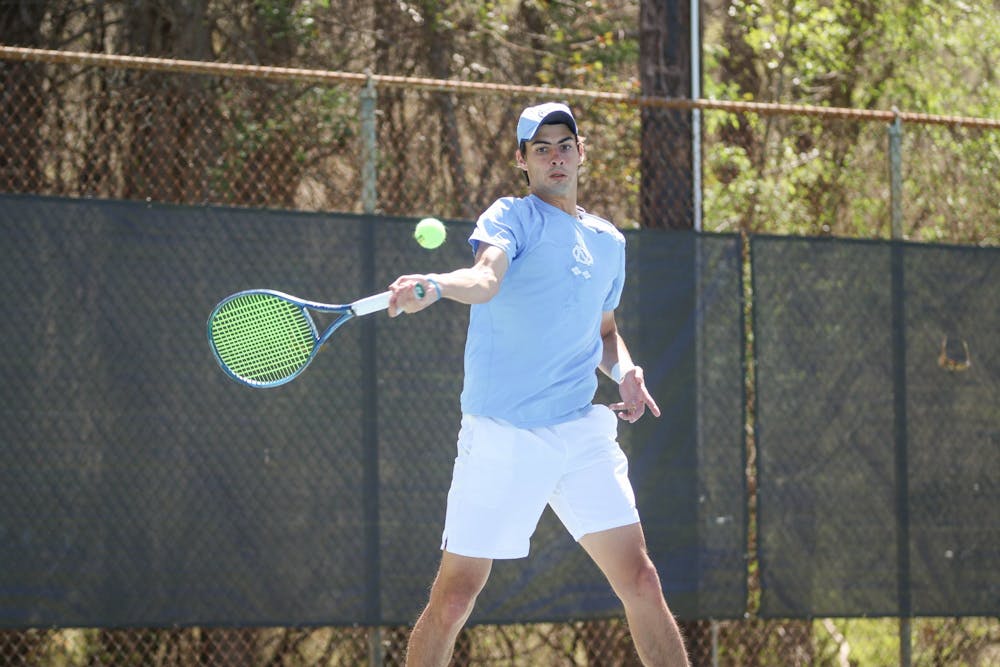 <p>DTH File. Sophomore Logan Zapp returns a serve with a forehand swing during his doubles match against Georgia Tech on Sunday, April 3, 2022.</p>
