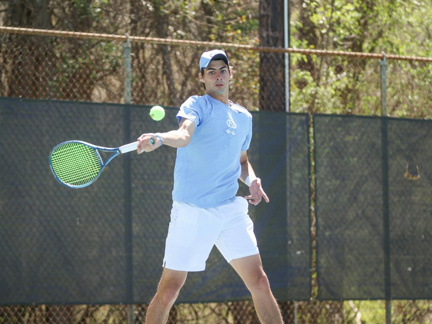 DTH File. Sophomore Logan Zapp returns a serve with a forehand swing during his doubles match against Georgia Tech on Sunday, April 3, 2022.