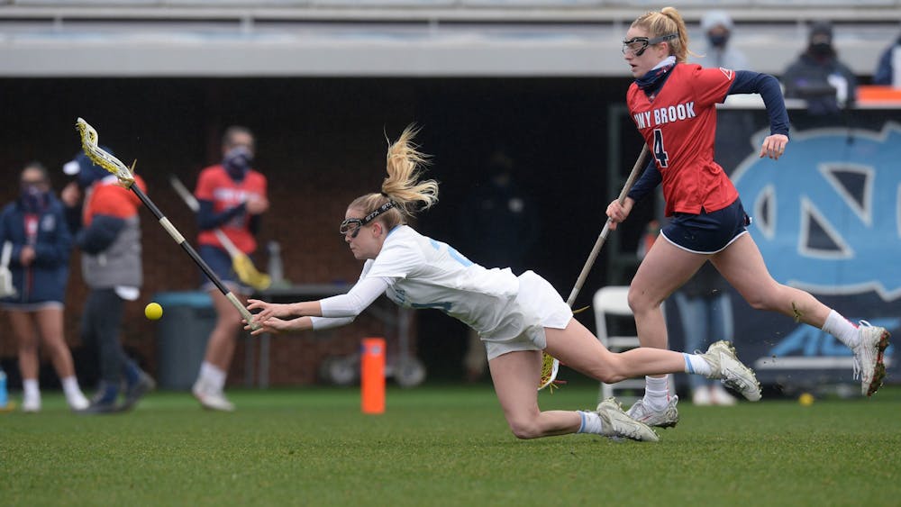 Redshirt sophomore midfielder Elizabeth Hillman lunges for the ball at the woman's lacrosse game against Stony Brook University at Dorrance Field on Sunday, Feb. 14, 2021. Photo courtesy of Jeffrey Camarati/UNC Athletics.