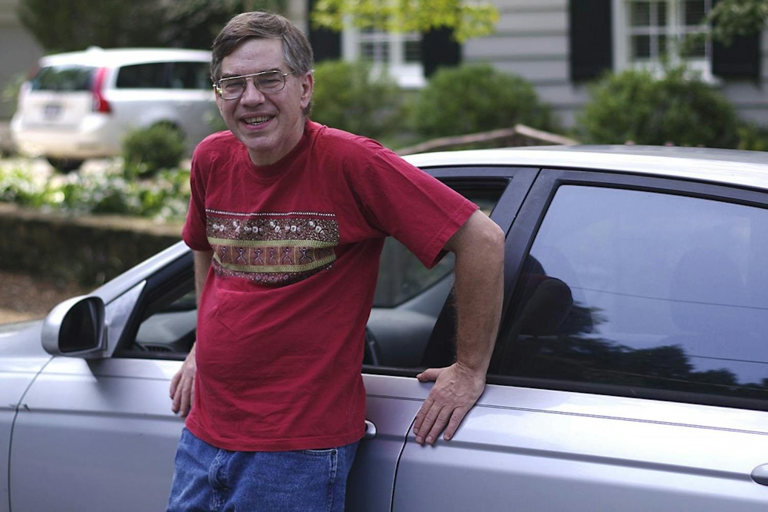 Libertarian candidate and pizza delivery man, Sean Haugh, stands in front of his car on August 16th, 2014.
