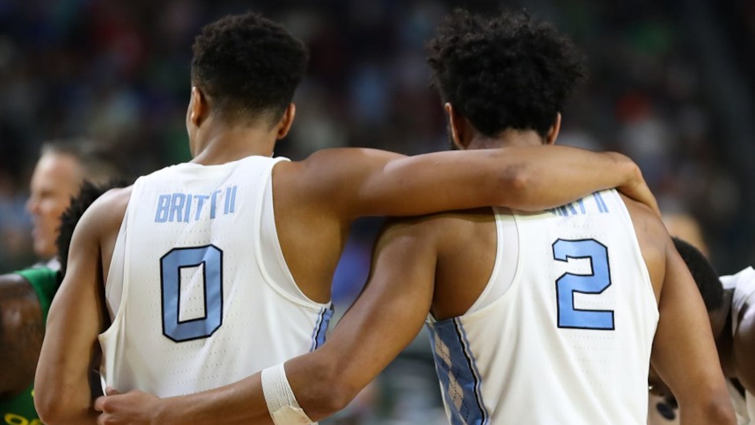 North Carolina guards Nate Britt (0) and Joel Berry (2) share a moment of embrace in between plays against Oregon in their Final Four matchup on Saturday in Phoenix.
