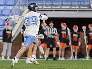 UNC junior goalkeeper Collin Krieg (39) clears the ball during the men’s lacrosse game against Mercer at Dorrance Field on Friday, Feb. 10, 2023. UNC won 25-3.