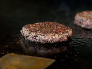 Burgers cook on a grill at Al’s Burger Shack on Wednesday, March 8, 2023. The restaurant is currently switching beef providers.
