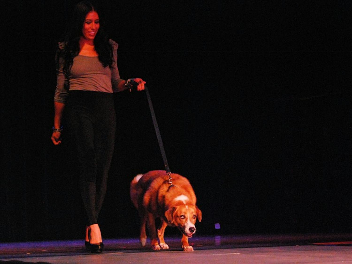 Sophomore Nicole Suarez from Miami walks down the runway of a fashion show hosted by UNC ‘s Helping Paws on Saturday to benefit the Orange County Animal Services Center’s spay and neuter initiatives. 