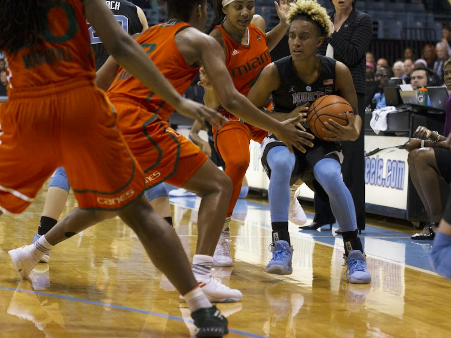 Guard Paris Kea (22) is trapped by two Miami defenders during a Feb. 4 game in Carmichael Arena.