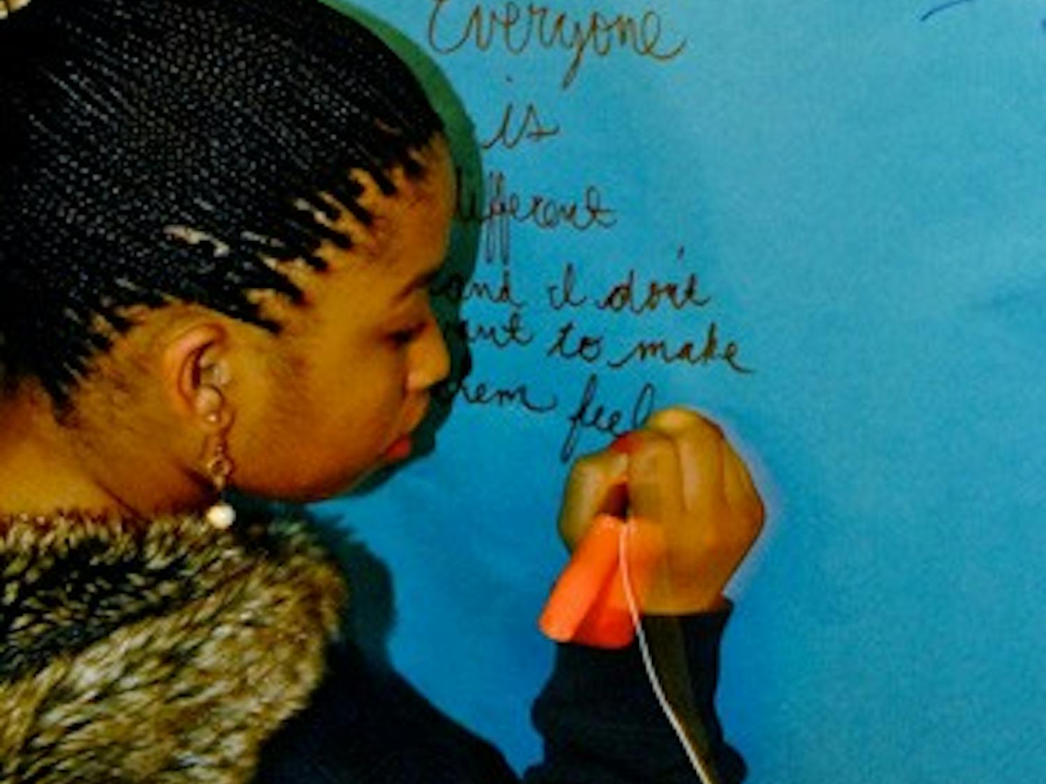 Sophomore Daisa Robinson reflects on the impact of the Tunnel of Oppression in Cobb Residence Hall. DTH/ /Helen Woolard