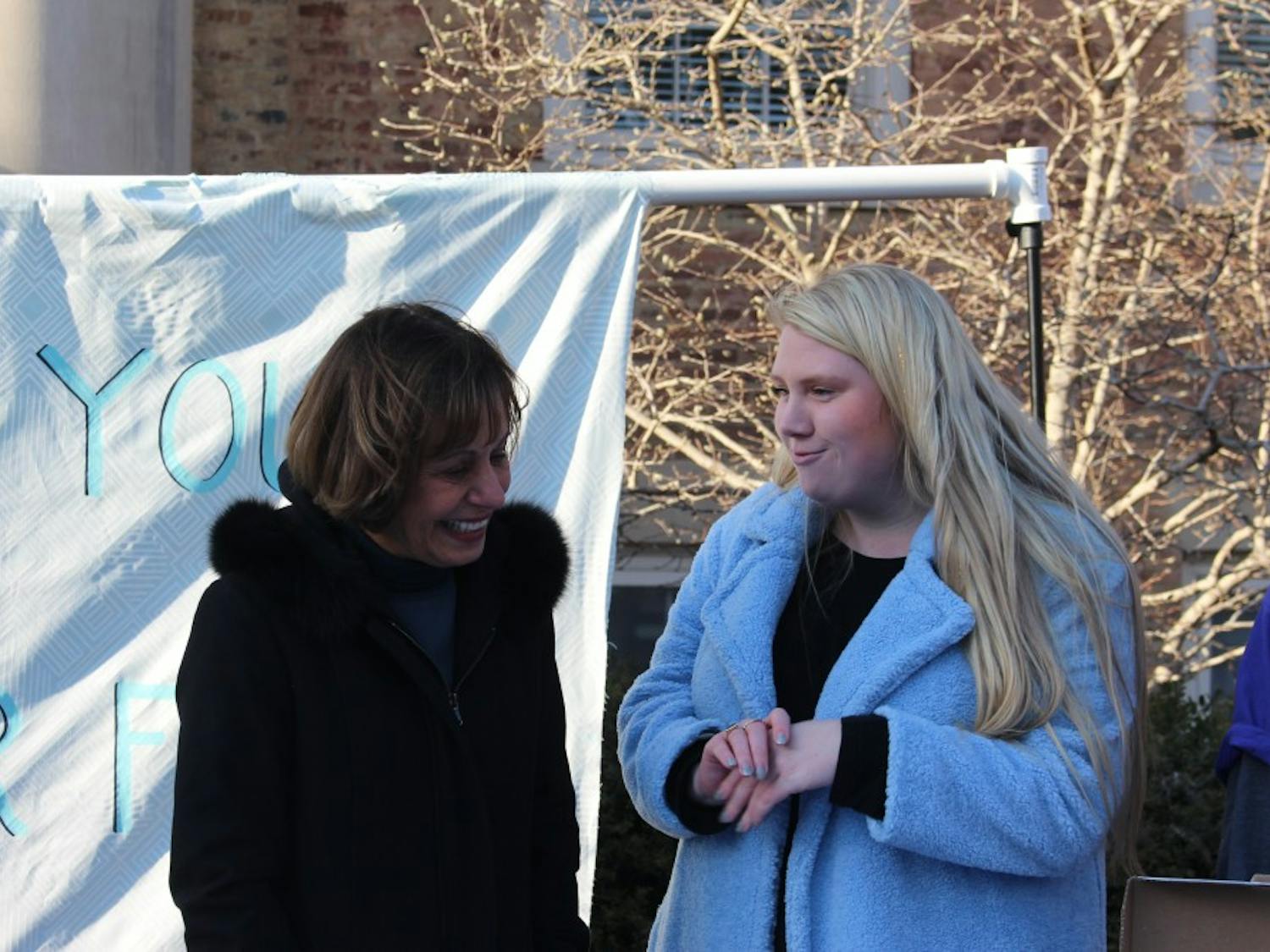 Senior Caroline Bass talks to Chancellor Carol Folt on the steps of South Building on Wednesday, Jan. 30, 2019. Bass organized the goodbye event to thank Folt during her final days at the university.