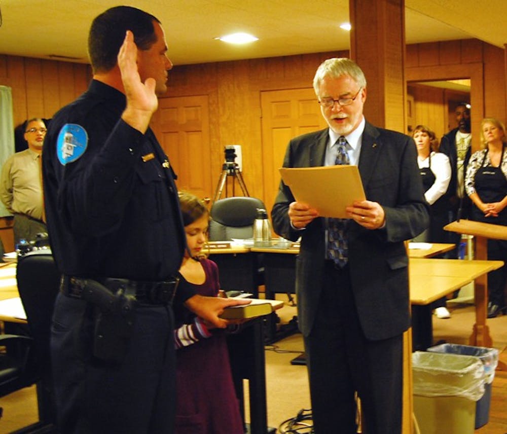 Duane Hampton is sworn in as the new Chief of Police in Hillsborough by Mayor Tom Stevens on Monday at the Hillsborough Town Barn.