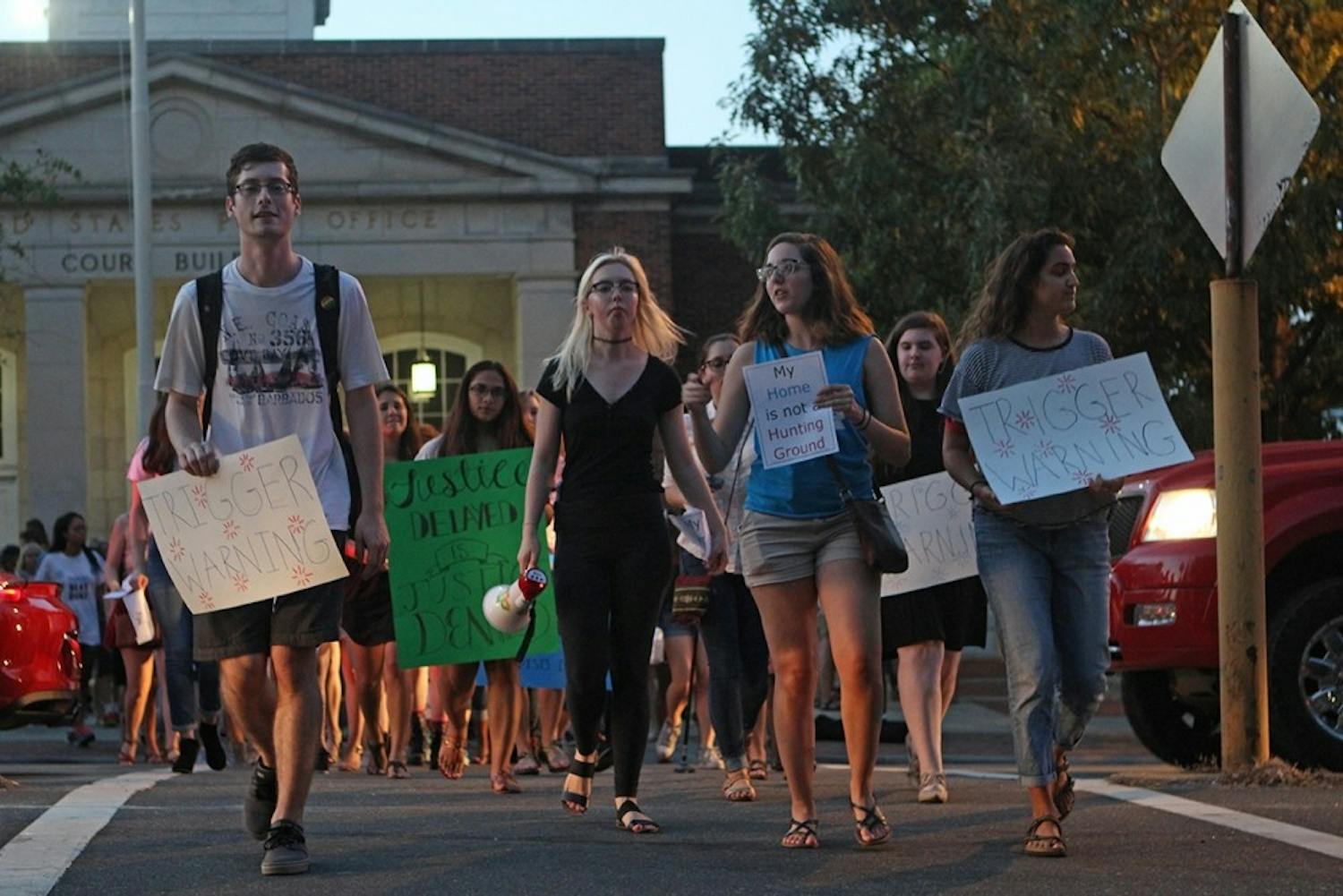 Demonstrators march from the Peace and Justice Plaza on Franklin Street on Friday evening.