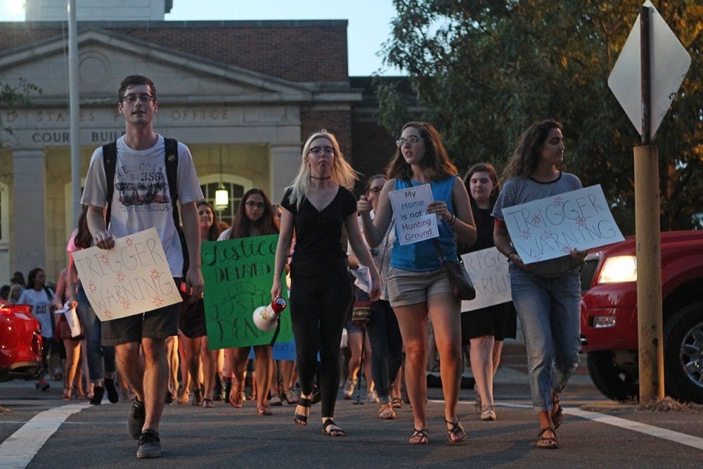 Demonstrators march from the Peace and Justice Plaza on Franklin Street on Friday evening.