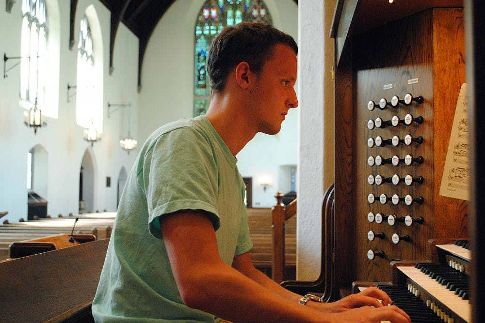 Senior Eric J. Surber practices playing the organ at Chapel of the Cross, where he has been performing at various services for three years. 